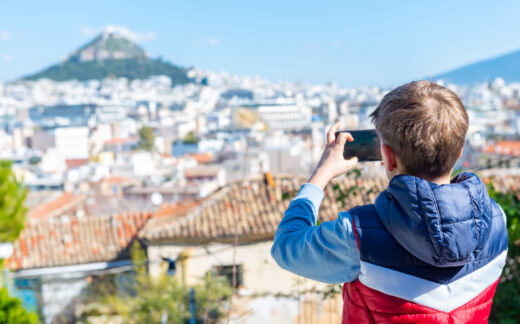 Boy taking photo of Lycabettus Hill